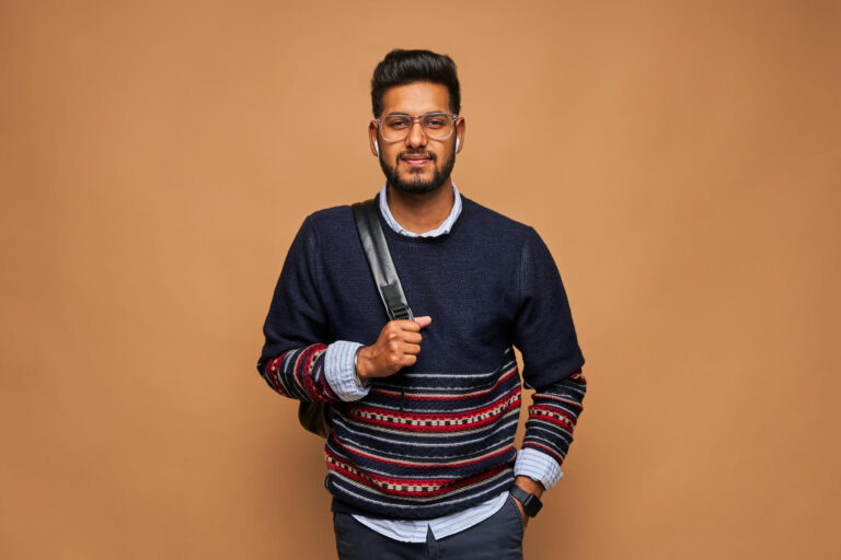 young-bearded-hindu-student-with-backpack-pastel-wall